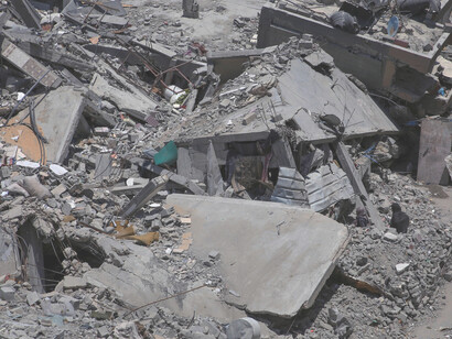 Ruined buildings stand as silent witnesses to the relentless cycles of violence and the urgent need for resolution and justice