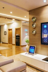 A high-tech living room where digital interfaces regulate lighting, entertainment, and climate, conveying the future of residential design