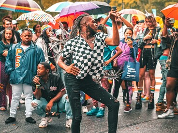 A performer expressing resistance through dance in the rain at a political protest