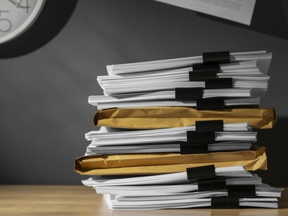 Piles of archived documents represent the growing public demand for transparency surrounding UFO and UAP records