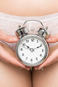 Girl holding an alarm clock, symbolizing the importance of tracking menstrual cycles and self-care