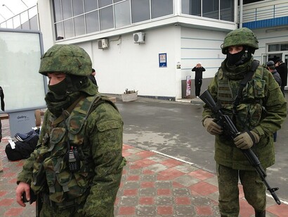 Armed men without insignia, widely referred to as “little green men,” at Simferopol Airport on 28 February 2014 during the early stages of Russia’s covert operation in Crimea