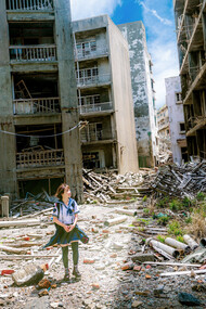 A girl walks amidst a wrecked and war torn city