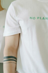 People wearing white-themed shirts with slogans such as ‘No Planet B,’ representing sustainable fashion and eco-friendly clothing for the future