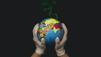 Cradling the Earth in gloved hands, a promising seed begins to sprout
