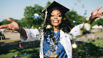 Celebrating her university graduation with exuberance, an African American woman joyfully throws confetti, marking the culmination of her academic journey and the beginning of a new chapter in her life