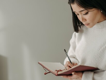 A close-up of thoughtful journaling, symbolising the decision to rewrite your story with compassion instead of regret
