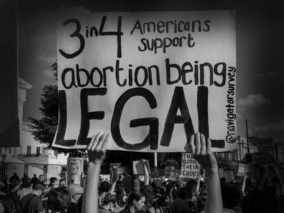 Someone holding up a sign that says "3 in 4 Americans support abortion being legal" is an indication of their fury from the decision to overturn Roe v. Wade 