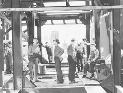 Workers on a high-rise building, talking about work