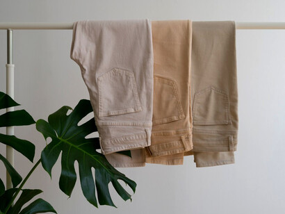 Light brown beige pants neatly hung on hangers