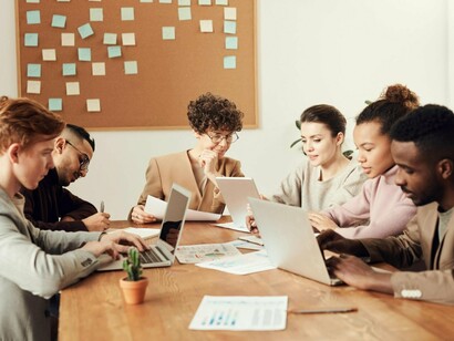 Employees focused on optimizing productivity through devices, symbolising the unnoticed entry points for data exposure