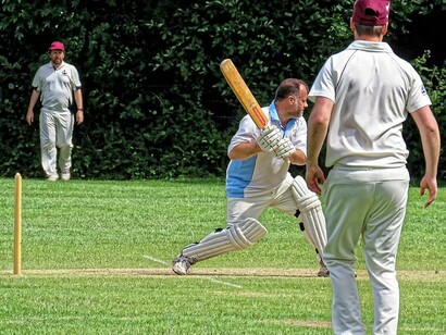 A public Sunday match in June 2019 between Old Finchleians Cricket Club Friendly XI (batting) and Highgate Taverners Cricket Club 1st XI at the Old Finchleians Memorial Ground, Woodside Park, Barnet, London, UK