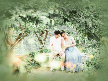 Two people sitting together in the forest in love