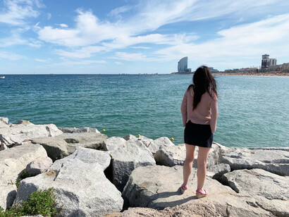 A woman gazes out to the Mediterranean Sea from the Spanish coastline