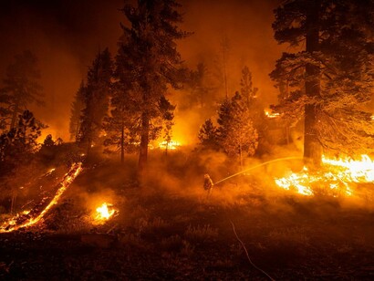 Firefighters with Cal Fire conduct an operation to contain the Dixie fire south of Highway 44 in Lassen National Forest, on August 27, 2021 captured by Lynsey Addario