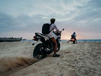 People on motorbikes on the beach