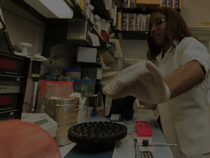 Chanelle Case Borden, Ph.D., a postdoctoral fellow in the Experimental Immunology Branch at the National Cancer Institute, expertly pipettes DNA samples into a tube as part of the polymerase chain reaction (PCR) process, a laboratory technique employed to replicate segments of DNA with precision