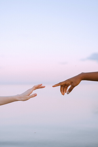 Two hands reaching for each other