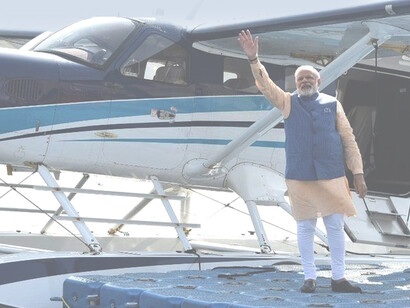 Narendra Modi waving to crowds