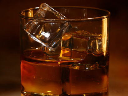 A glass of bourbon, chilled with ice