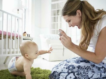 A mother takes pictures of her baby