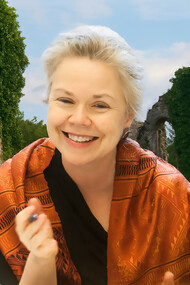 Susan Stewart pictured against a backdrop of ancient ruins, reflecting her lifelong engagement with memory, materiality, and the traces of the past
