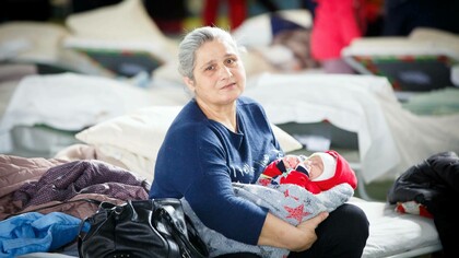 Ukrainian refugee Nagir holds her granddaughter at a refugee center, Moldova. UNFPA Moldova, Eduard Bîzgu, 4 March 2022