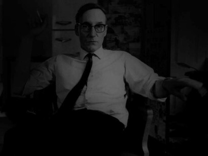 William Burroughs posing with his customary cigarette in hand