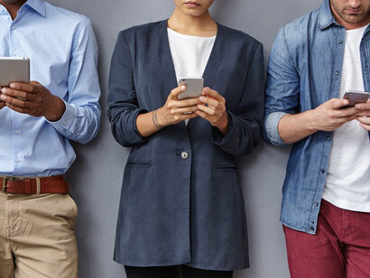 People gathered with smartphones and tablets, showcasing the pervasive dependency on technology and its role in information overload