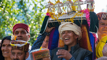 A group of people in traditional Himachali attire gathered in a circle, Kullu Valley, Himachal Pradesh, India