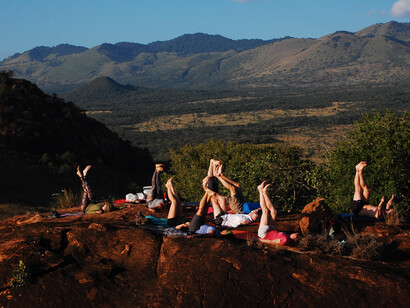 Yoga retreat goers from Modo Yoga on top of a look out hill at Campi ya Kanzi
