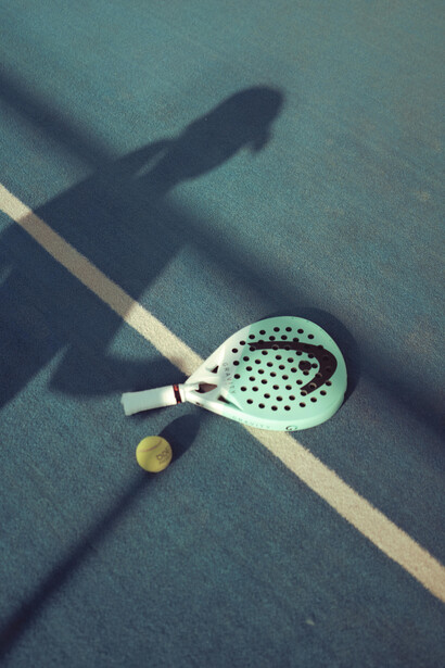 Shadow of a padel racket on a modern padel tennis court surface