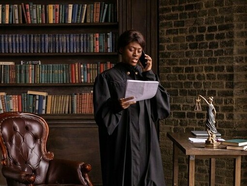 A judge carefully reviewing legal documents, symbolizing the careful balance between legal responsibility and institutional practice