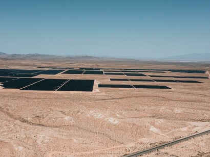 United States: Aerial view of vast solar panels stretching across a desert landscape