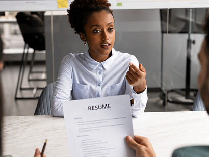 African American woman speaking with a company HR team during a recruitment interview