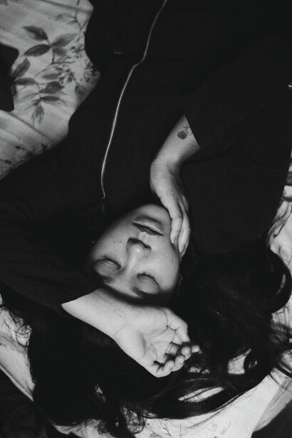 A woman sleeping peacefully, detoxing from the day