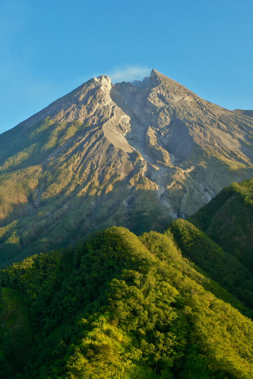 A breathtaking view of Mount Merapi in Indonesia, where the cool air and stunning panoramas offer a moment of peace amidst the volcano's imposing presence