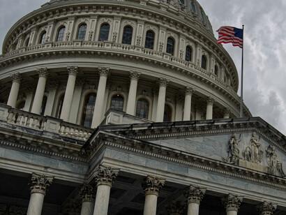 The United States Capitol in Washington, D.C., with the American flag flying outsid