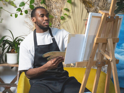 With the brush in hand and a canvas before him, the artist reflects the growing role of artificial intelligence in art, where technology serves as a collaborator, not a replacement, for the human creative spirit