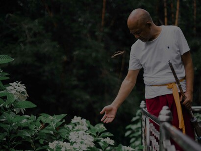 A man tending to his garden and showing the love and compassion he has for what is blossoming in front of him