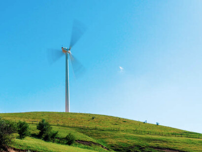 Wind turbines dotting the green valley of Uzbekistan, powering the transition to renewable energy