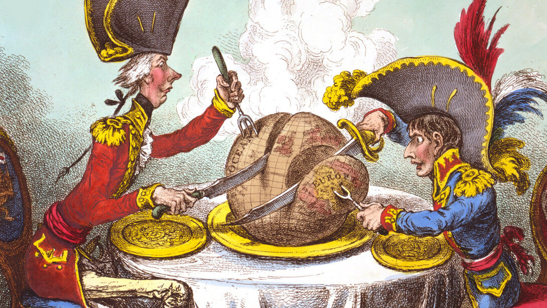 William Pitt, wearing a regimental uniform and hat, sitting at a table with Napoleon. They are each carving a large plum pudding on which is a map of the world by James Gillray 