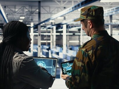 An army commander works with a software developer to operate an AI-powered radar system inside a data center