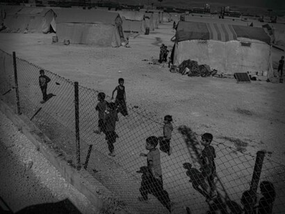 Children run back and forth in a refugee camp in Syria