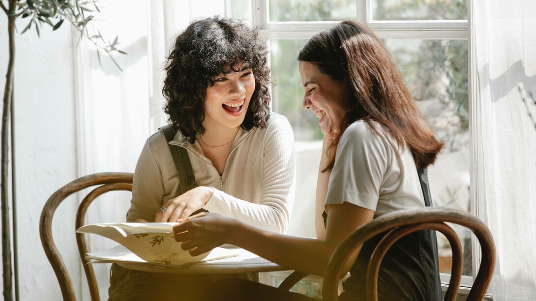 A couple of friends sharing a laugh during their break at their workplace