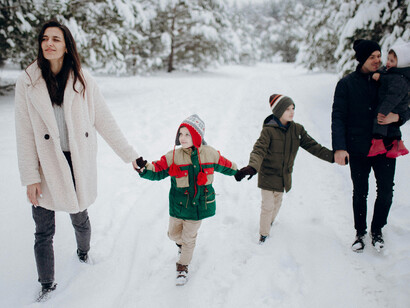 Active family having fun in the snow, celebrating winter together