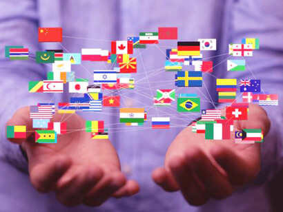 Flags of different countries held by a person, symbolizing the unity in international development projects, development cooperation, and the collective effort for sustainable development between the Global South and North