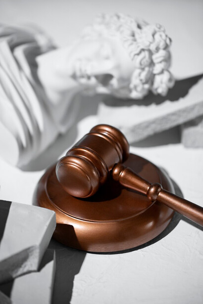 Scales of justice resting on a pristine white surface