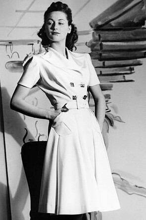 Model in a double-breasted dress and platform sandals with cork soles