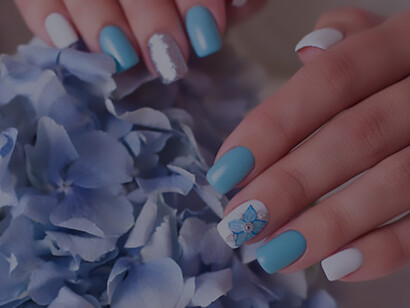 Adorned with romantic manicure nails, female hands gracefully rest on peonies, adding a touch of elegance to your style